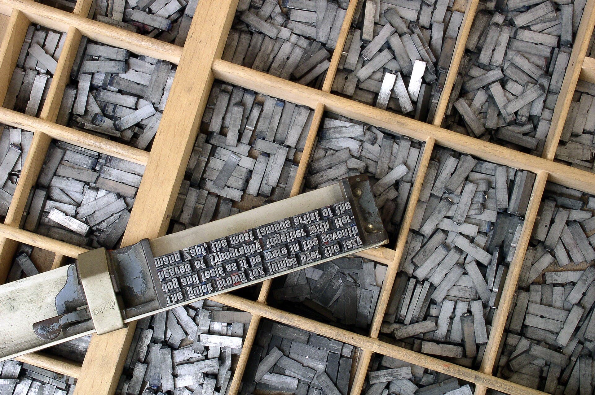 Close-up of metal movable type letters arranged in a case.