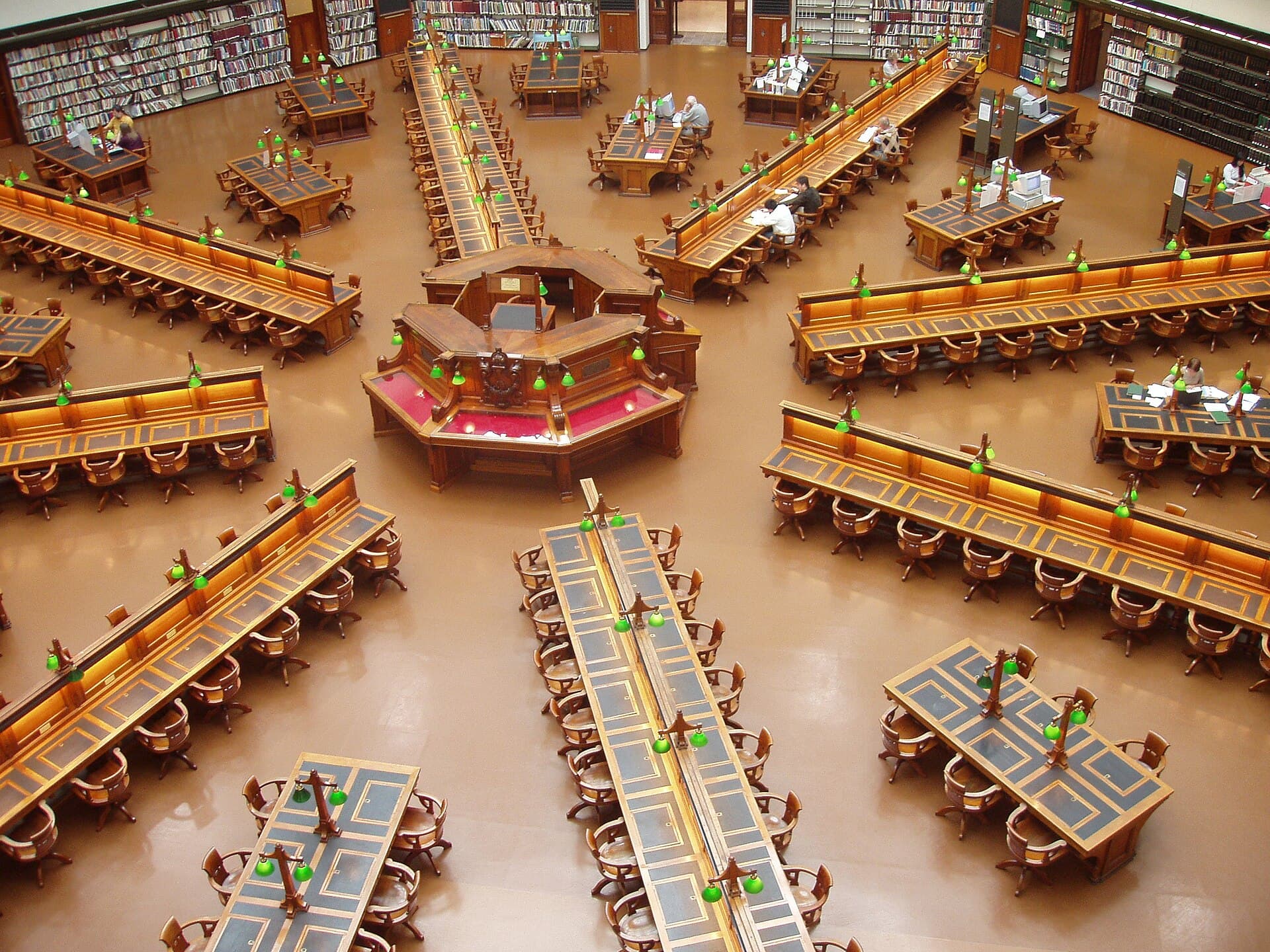 The reading room of the State Library of Victoria, with desks arranged under the dome.