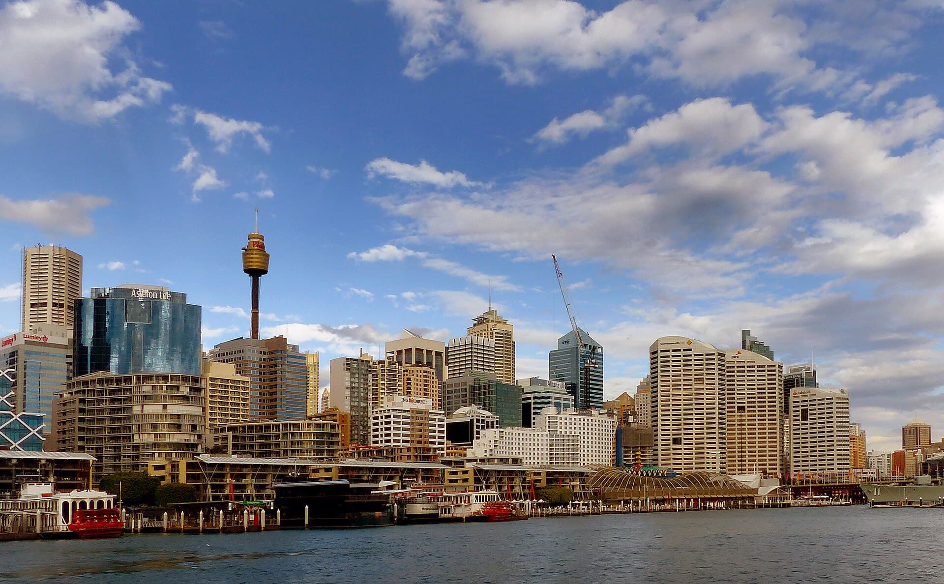 Sydney’s skyline from Darling Harbour, with office towers stacked above the water.